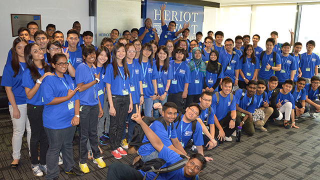 Group shot of Heriot-Watt Malaysia's first batch of staff and students wearing matching blue tshirts