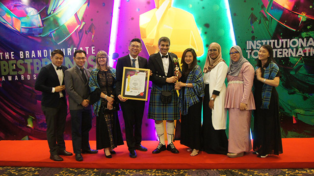 group of staff accepting BrandLaureate's 'Most Iconic Brand' Award