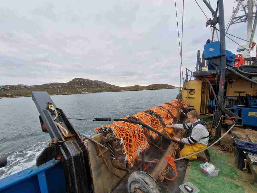 A researcher test a new fishing gear on a boat