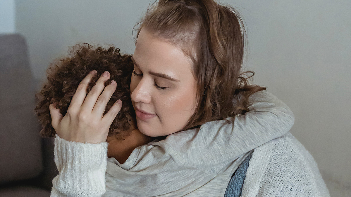 A mother hugs her child