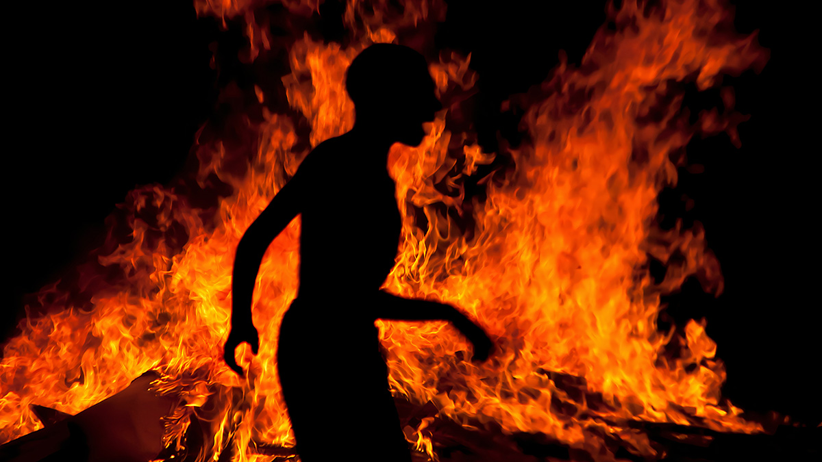 Shadow of person in front of fire