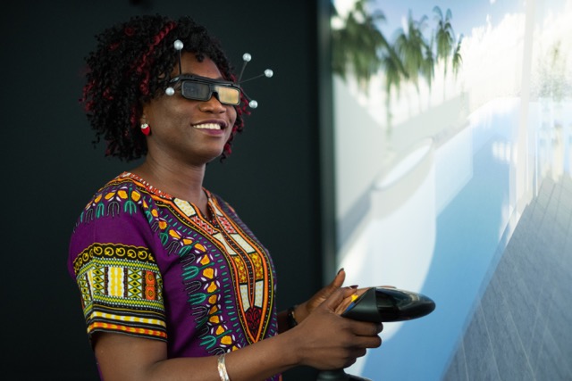 Woman using virtual reality headset in imagineering virtual reality suite