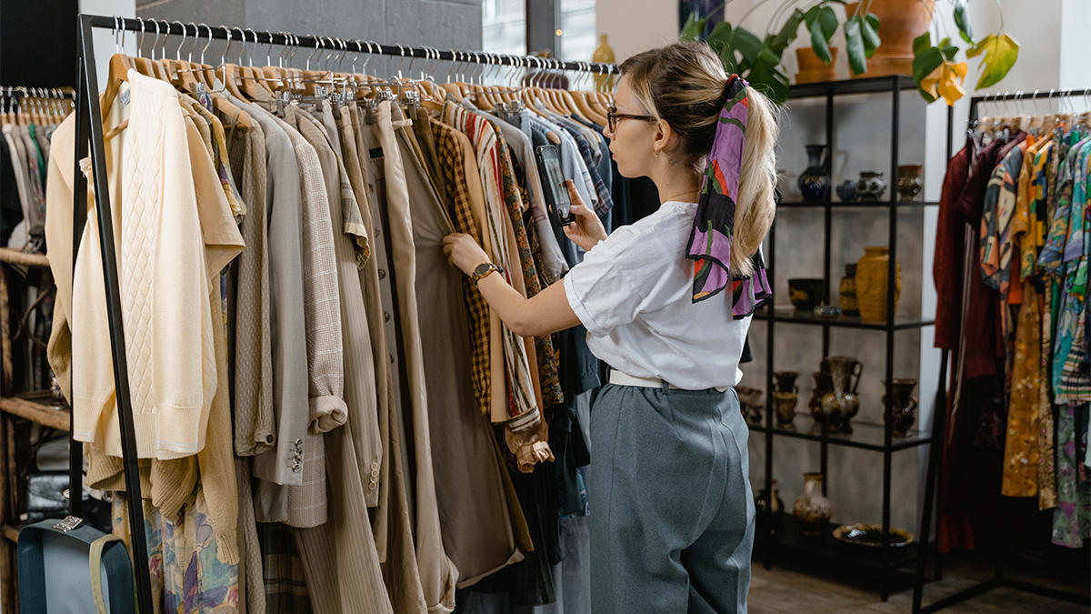 Woman looking at clothes on a rail.