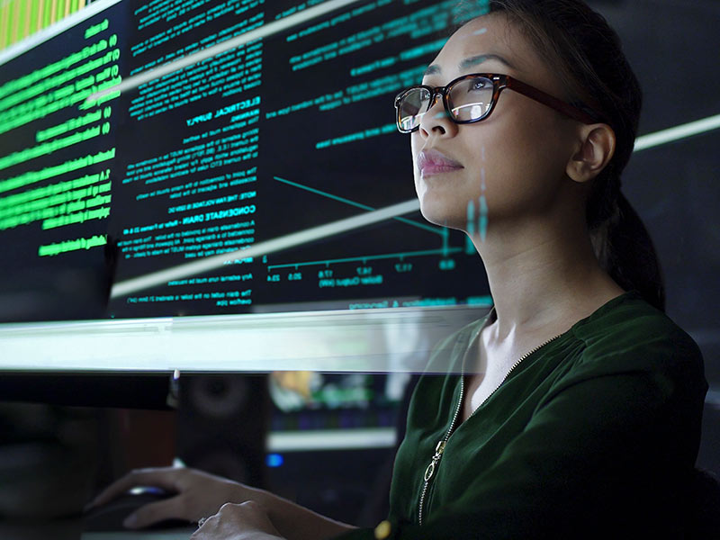 woman using computer. The text from the text from the screen overlays her face