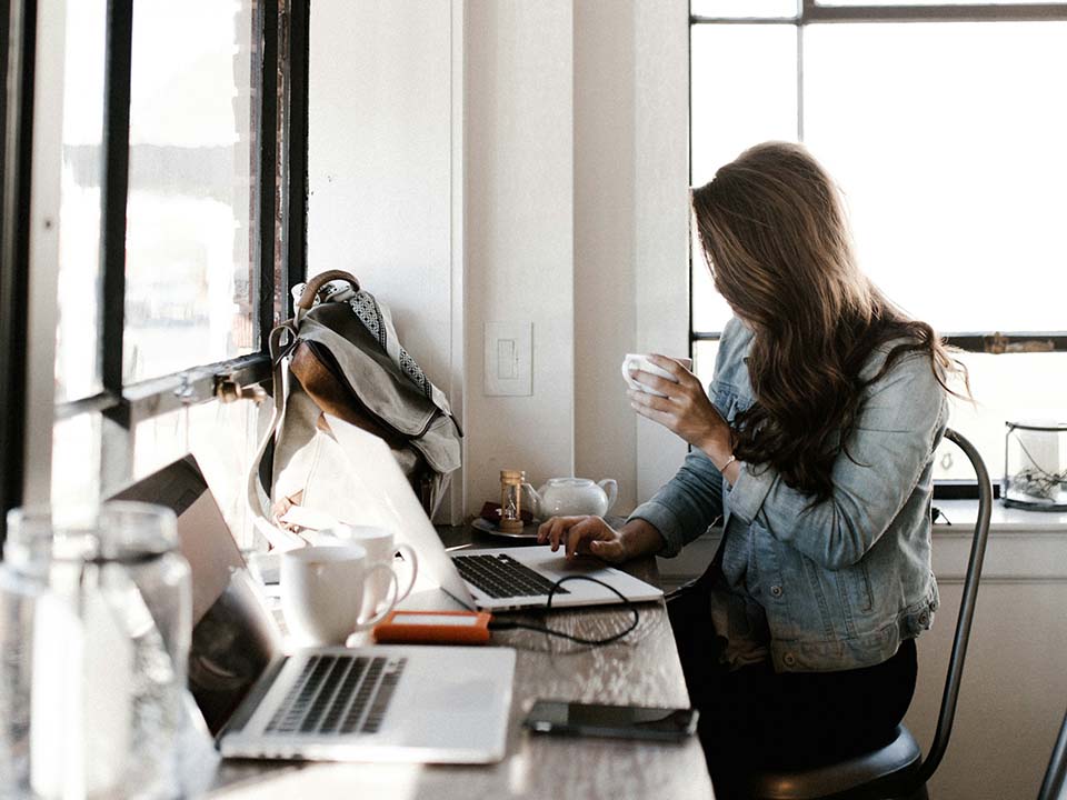 Woman using a laptop in a cafe