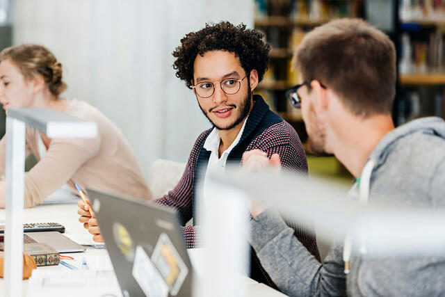 Two people having a discussion in an office