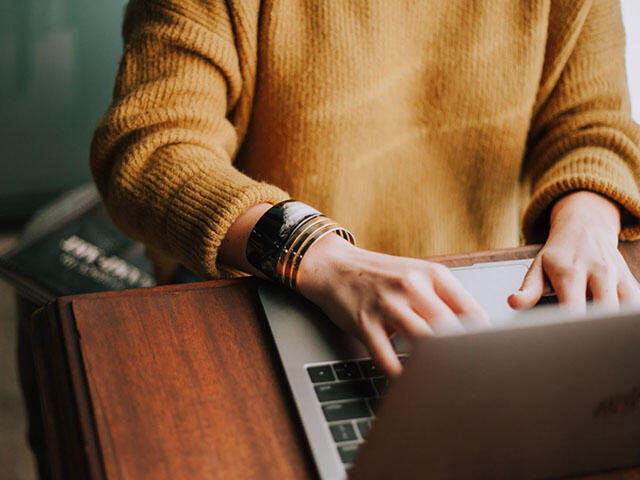 Woman using a laptop computer on a table