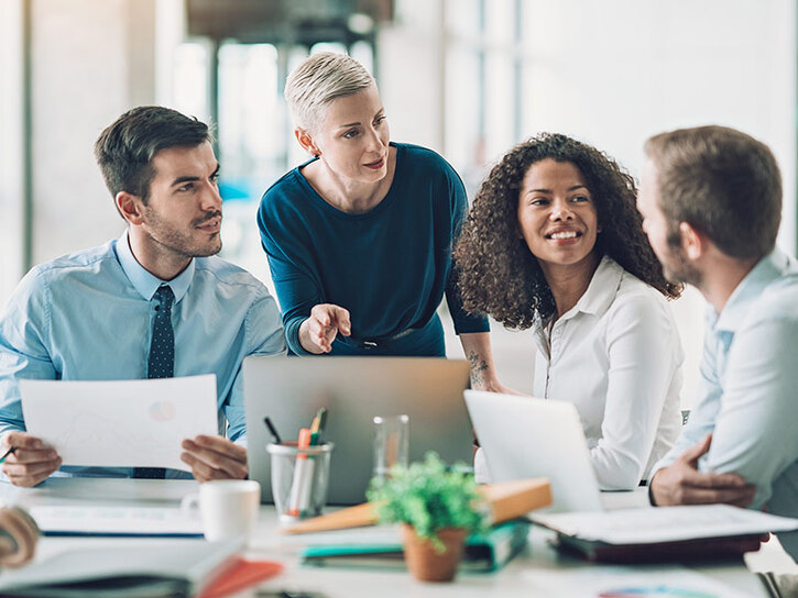 A group of business people in discussion around a desk