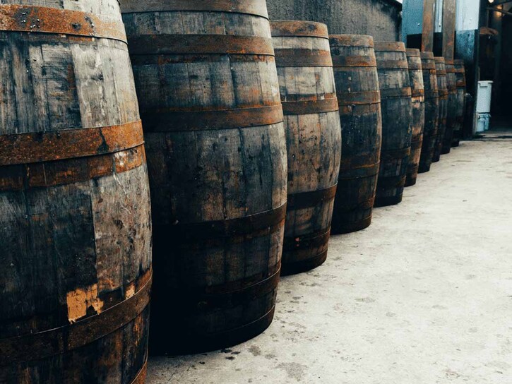 A row of wooden barrels in a brewery yard