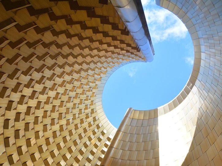 worms view of gold building spiralling up to sky