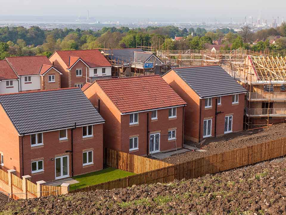 A row of detached newly built houses on a development