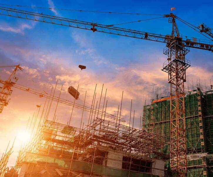 scaffolding and a crane at dusk