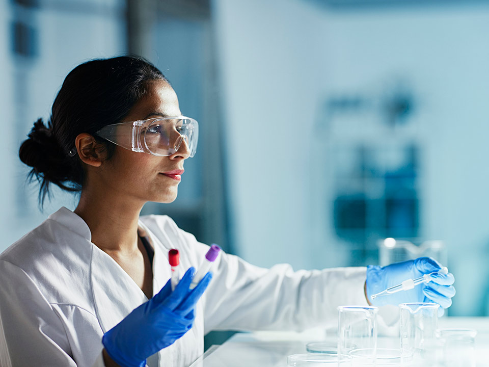 female chemical engineer testing sample in lab