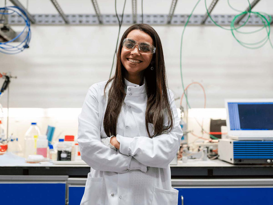 Woman chemical engineer in white safety coat in a laboratory