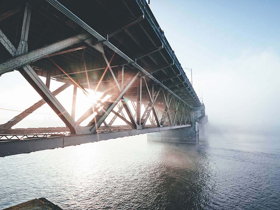 structural support of a bridge disappearing into distance