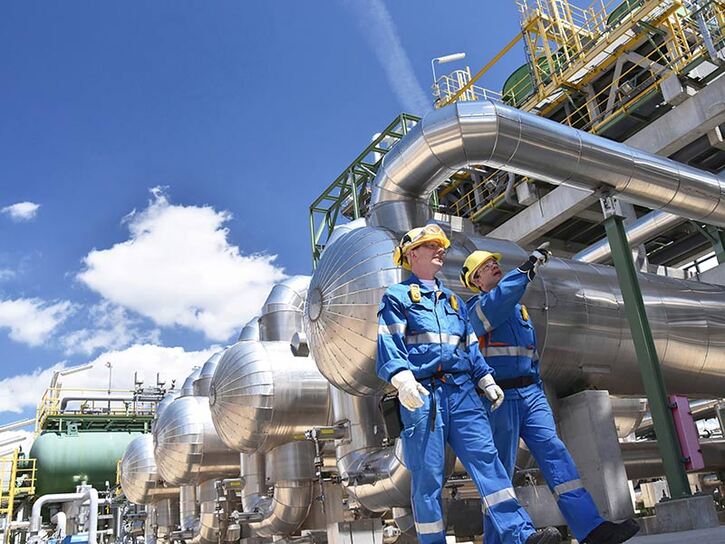 two mechanical workers in a refinery