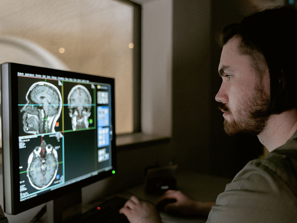 man looking at brain scan