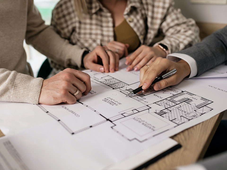estate agent showing house floorplans on paper