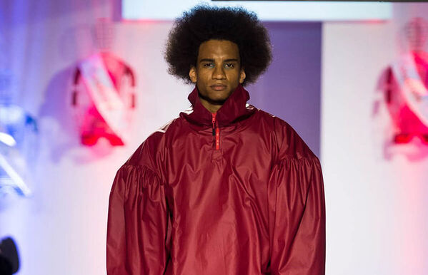 male model walking catwalk, wearing oversized red jacket