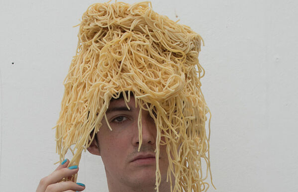 headshot of Jack Shanks wearing a hat made of spaghetti