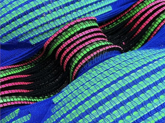 blue pink and green woven textiles