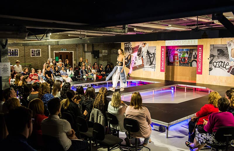 rectangular runway of fashion show with audience surrounding