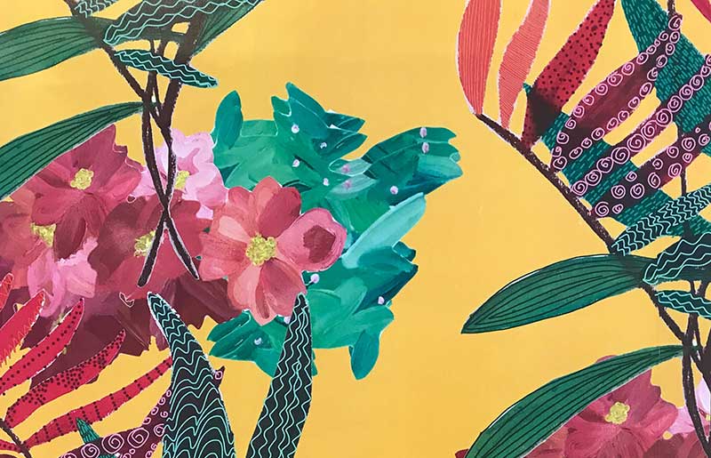 print of jungle leaves and pink flowers on a yellow background