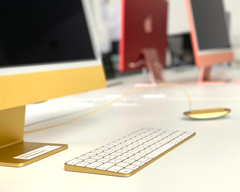 yellow iMac keyboard and mouse on desk