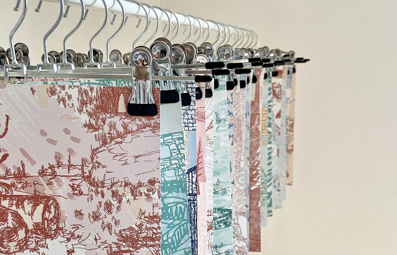 floral print pink and blue textiles hanging on a rail