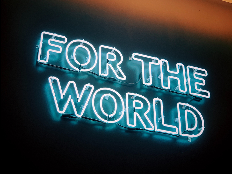 Neon sign that says FOR THE WORLD