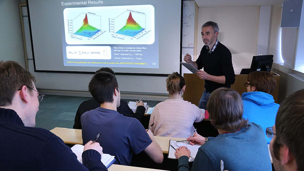 students taking notes in traditional classroom physics lecture