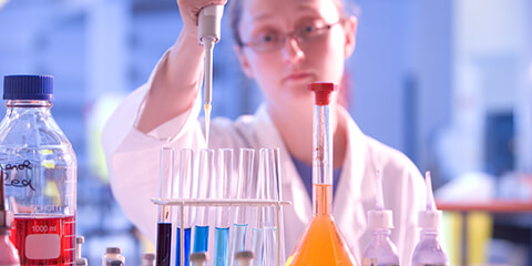 Lab worker using pipette