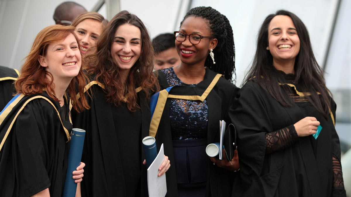 Group of female graduates holding their graduation scrolls